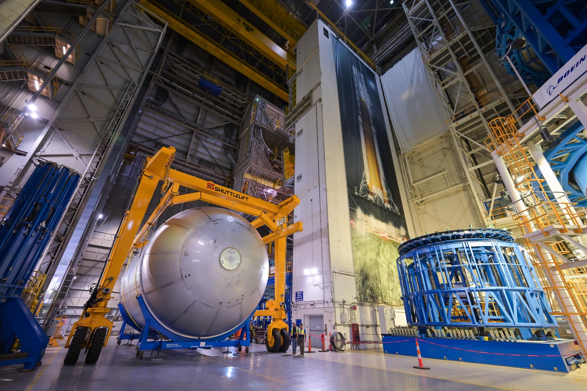 Teams at NASA’s Michoud Assembly Facility in New Orleans move a liquid oxygen tank from the main rocket factory into the adjacent vertical assembly building. The liquid oxygen tank, which will form part of the SLS (Space Launch System) rocket for NASA’s Artemis IV mission to the Moon, is rotated from a horizontal to a vertical configuration and loaded into the high bay’s hydrostatic proof testing cell. This non-destructive evaluation method tests the structural integrity of the tank’s welds by filling the tank with water, simulating the propellant used during launch. The propellant tank will hold more than 196,000 gallons of super-cooled liquid oxygen at launch and is one of five major elements that make up the 212-foot-tall SLS rocket stage. The core stage, along with its four RS-25 engines at its base, produces more than two million pounds of thrust to help launch NASA’s Orion spacecraft, astronauts, and supplies beyond Earth’s orbit and to the lunar surface for Artemis.